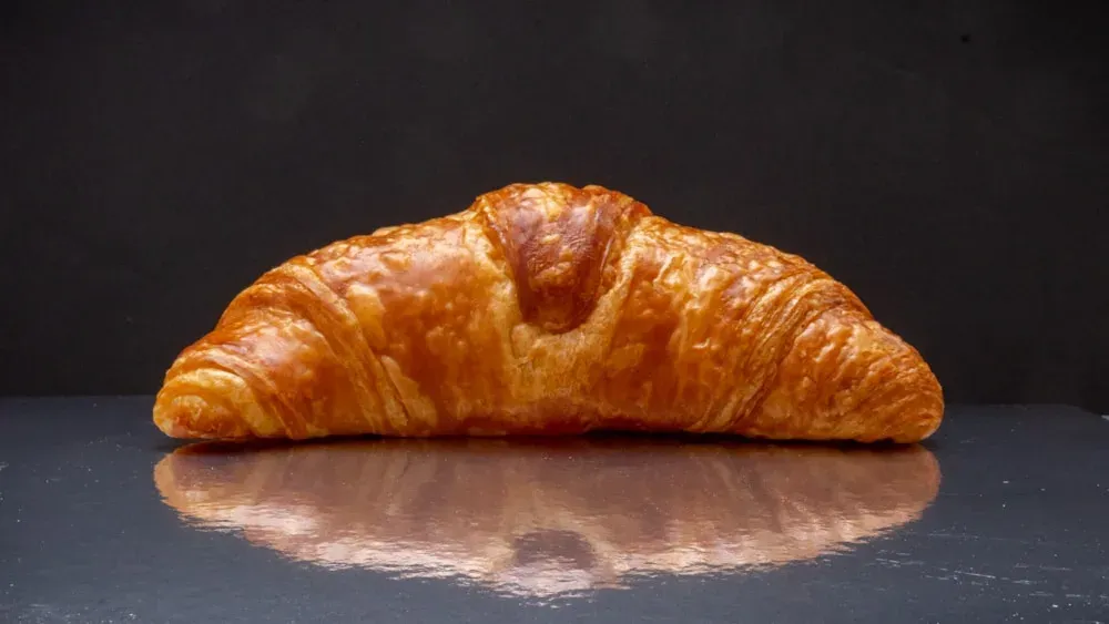 A golden croissant with delicate flaky layers